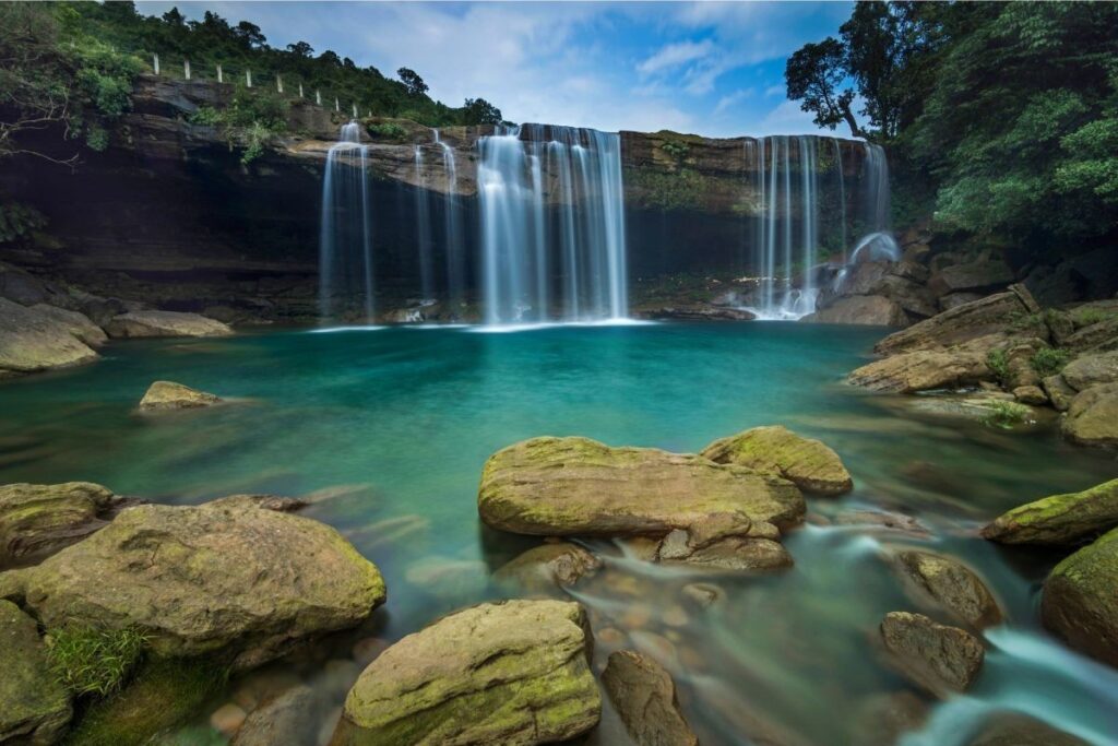 Krang Suri Waterfall in Meghalaya featuring its iconic blue natural pool and lush surroundings
