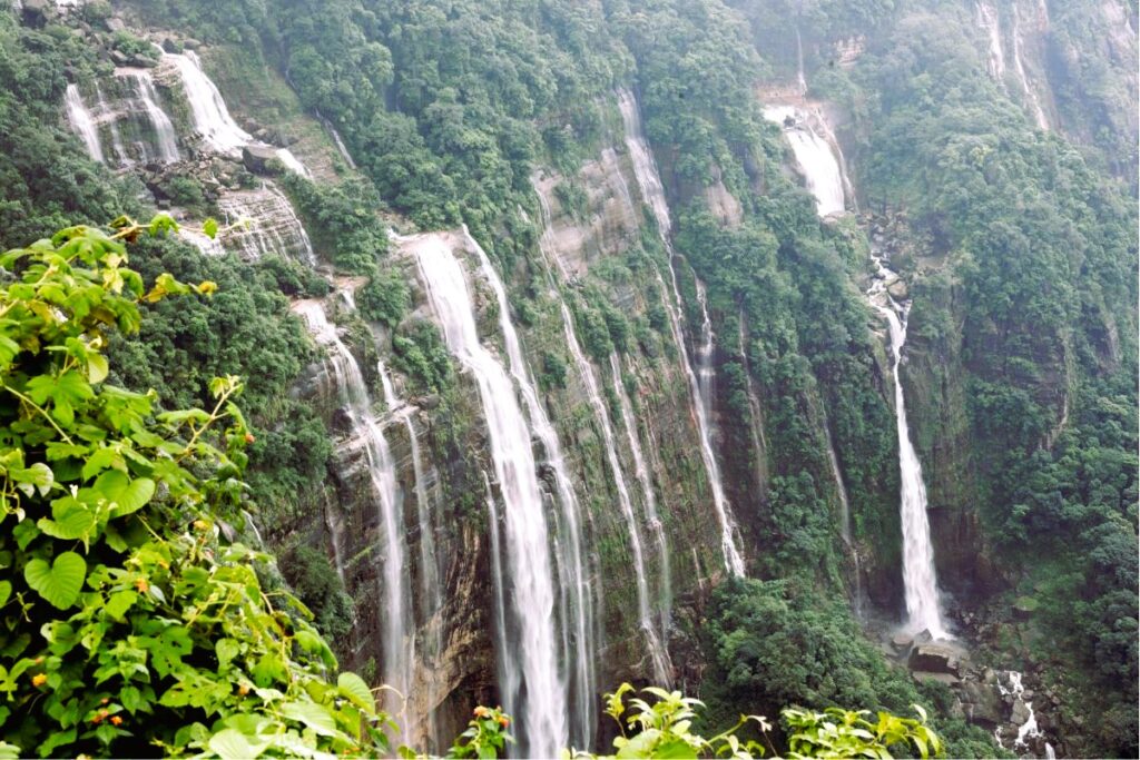 Seven Sisters Falls in Cherrapunji during peak monsoon, with all seven streams visible against deep rock walls and lush valleys