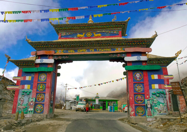 Snow-covered mountains and pine forests surrounding Tawang town