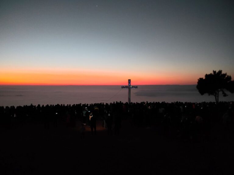 Panoramic view of Mawthei at dawn with golden sunlight and misty valleys.